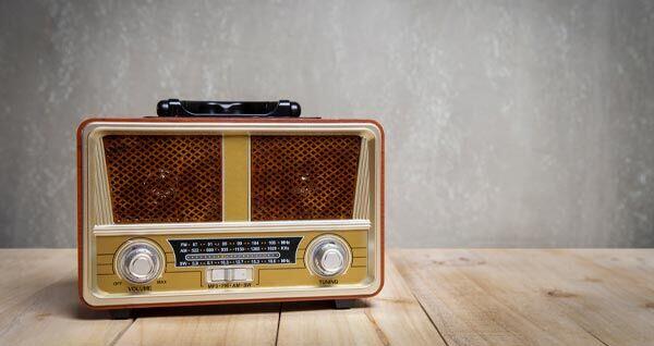 Photo of an old transistor radio on a wooden tabletop